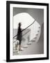 Woman walking up staircase holding handrail-John Edward Linden-Framed Photo