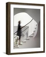 Woman walking up staircase holding handrail-John Edward Linden-Framed Photo