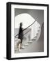 Woman walking up staircase holding handrail-John Edward Linden-Framed Photo