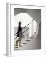 Woman walking up staircase holding handrail-John Edward Linden-Framed Photo