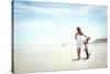 Woman Walking with Bicycle along Beach Sand Summer Lifestyle Carefree-warrengoldswain-Stretched Canvas