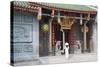 Woman Wearing Ao Dai Dress at Nghia an Hoi Quan Pagoda, Cholon, Ho Chi Minh City, Vietnam-Ian Trower-Stretched Canvas