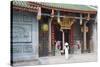 Woman Wearing Ao Dai Dress at Nghia an Hoi Quan Pagoda, Cholon, Ho Chi Minh City, Vietnam-Ian Trower-Stretched Canvas