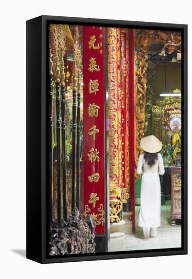 Woman Wearing Ao Dai Dress at Phuoc an Hoi Quan Pagoda, Cholon, Ho Chi Minh City, Vietnam-Ian Trower-Framed Stretched Canvas