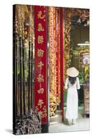 Woman Wearing Ao Dai Dress at Phuoc an Hoi Quan Pagoda, Cholon, Ho Chi Minh City, Vietnam-Ian Trower-Stretched Canvas