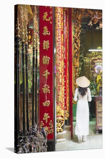 Woman Wearing Ao Dai Dress at Phuoc an Hoi Quan Pagoda, Cholon, Ho Chi Minh City, Vietnam-Ian Trower-Stretched Canvas