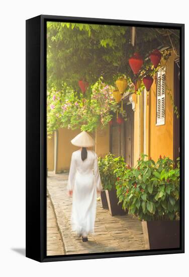 Woman Wearing Ao Dai Dress Walking Along Street, Hoi An, Quang Ham, Vietnam-Ian Trower-Framed Stretched Canvas