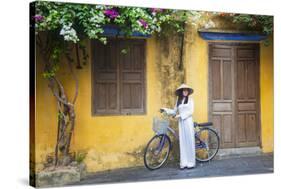 Woman Wearing Ao Dai Dress with Bicycle, Hoi An, Quang Ham, Vietnam-Ian Trower-Stretched Canvas