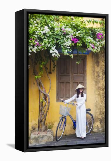 Woman Wearing Ao Dai Dress with Bicycle, Hoi An, Quang Ham, Vietnam-Ian Trower-Framed Stretched Canvas