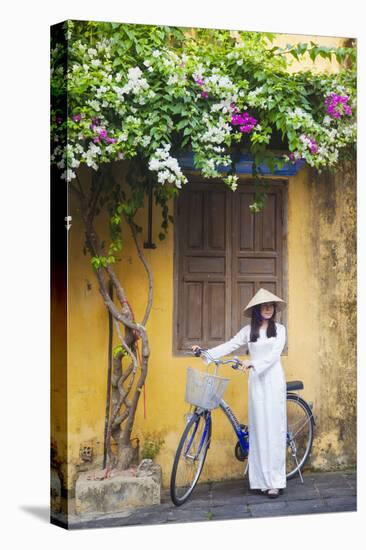 Woman Wearing Ao Dai Dress with Bicycle, Hoi An, Quang Ham, Vietnam-Ian Trower-Stretched Canvas