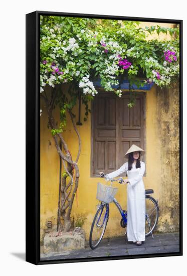 Woman Wearing Ao Dai Dress with Bicycle, Hoi An, Quang Ham, Vietnam-Ian Trower-Framed Stretched Canvas