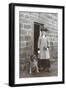 Woman with a Dog Outside a House-null-Framed Photographic Print