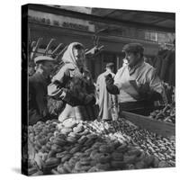 Woman with a Small Terrier Buying Bagels at a Market Stall, Possibly London, C.1945-50-null-Stretched Canvas