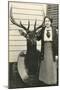 Woman with Mounted Deer Head-null-Mounted Art Print