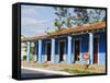 Woman With Parasol Walking Past a Colourful Building, Vinales Valley, Cuba, West Indies, Caribbean-Christian Kober-Framed Stretched Canvas