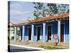 Woman With Parasol Walking Past a Colourful Building, Vinales Valley, Cuba, West Indies, Caribbean-Christian Kober-Stretched Canvas