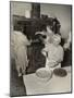 Women Cooking Spaghetti and Frying Chicken on an Old Stove for the Grape Festival-null-Mounted Photo