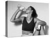 Women Drinking after Exercise Session in Fitness Studio, New York, New York, USA-Paul Sutton-Stretched Canvas