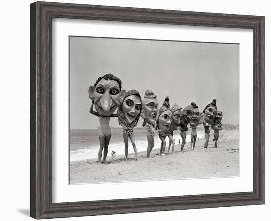 Women Holding Giant Masks-Bettmann-Framed Photographic Print