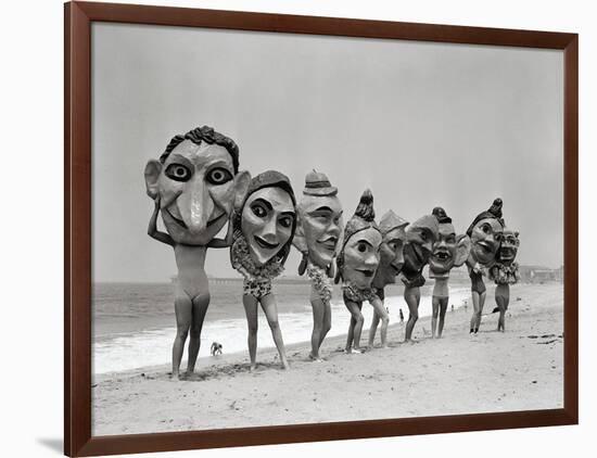 Women Holding Giant Masks-Bettmann-Framed Photographic Print