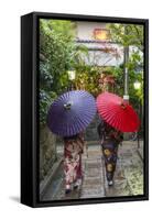 Women in traditional dress with umbrellas walking through Kyoto, Japan-Peter Adams-Framed Stretched Canvas