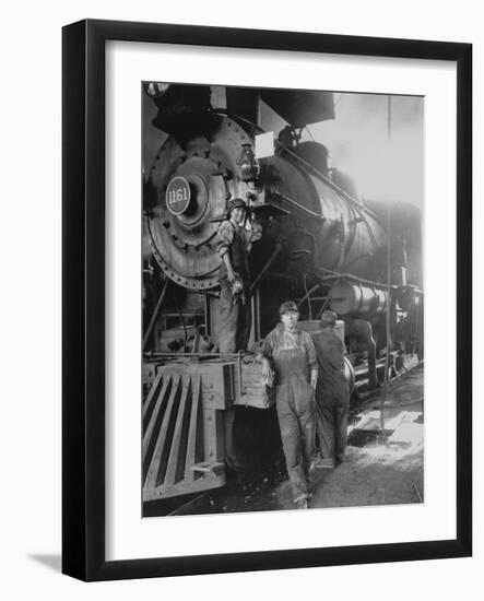 Women Rail Workers Standing at Work on Engine of Train, During WWI at Great Northern Railway-null-Framed Photographic Print