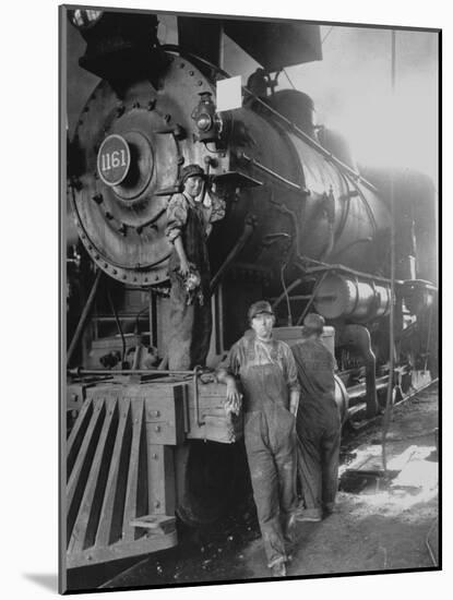 Women Rail Workers Standing at Work on Engine of Train, During WWI at Great Northern Railway-null-Mounted Photographic Print