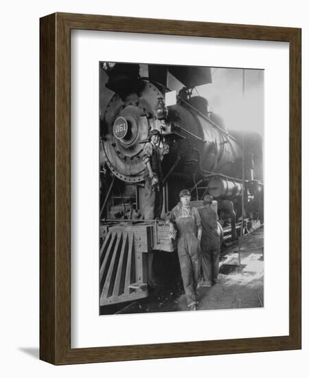 Women Rail Workers Standing at Work on Engine of Train, During WWI at Great Northern Railway-null-Framed Photographic Print