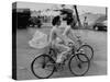 Women Riding Bicycles in Saigon-John Dominis-Stretched Canvas