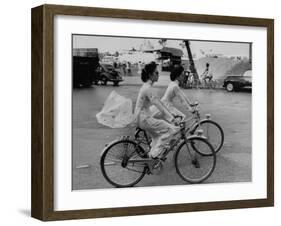 Women Riding Bicycles in Saigon-John Dominis-Framed Premium Photographic Print