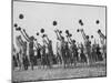 Women's Gym Class with Rows of Women Throwing Balls Into Air in Unison-null-Mounted Photographic Print