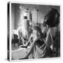 Women Sitting under Hair Dryers at the Hairdressers-Henry Grant-Stretched Canvas