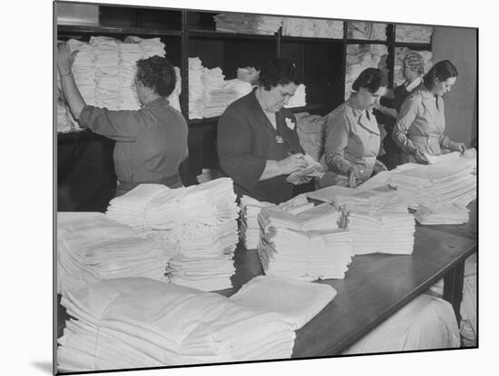 Women Sorting Clean Linens in Laundry Room at the Waldorf Astoria Hotel-null-Mounted Photographic Print