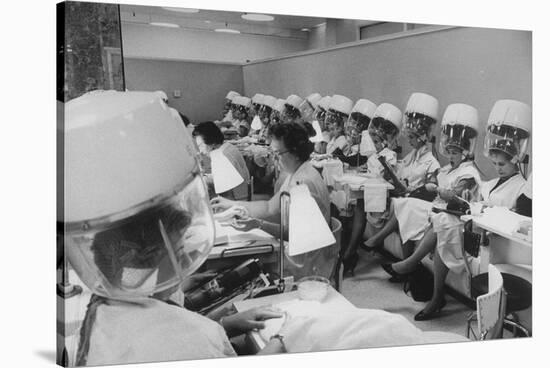 Women under Hair Dryers Getting Hair Styled in Beauty Salon at Saks Fifth Ave. Department Store-Alfred Eisenstaedt-Stretched Canvas