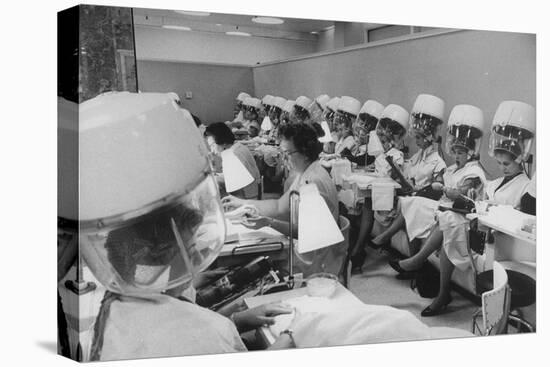 Women under Hair Dryers Getting Hair Styled in Beauty Salon at Saks Fifth Ave. Department Store-Alfred Eisenstaedt-Stretched Canvas