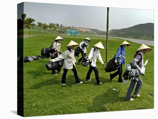Women Wearing the Traditional Vietnamese Conical Hats Haul Golf Clubs-null-Stretched Canvas