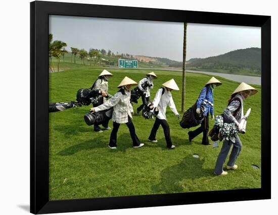 Women Wearing the Traditional Vietnamese Conical Hats Haul Golf Clubs-null-Framed Photographic Print