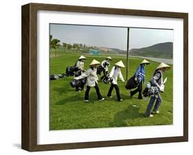 Women Wearing the Traditional Vietnamese Conical Hats Haul Golf Clubs-null-Framed Photographic Print