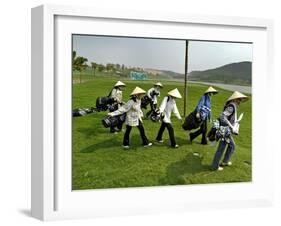 Women Wearing the Traditional Vietnamese Conical Hats Haul Golf Clubs-null-Framed Photographic Print