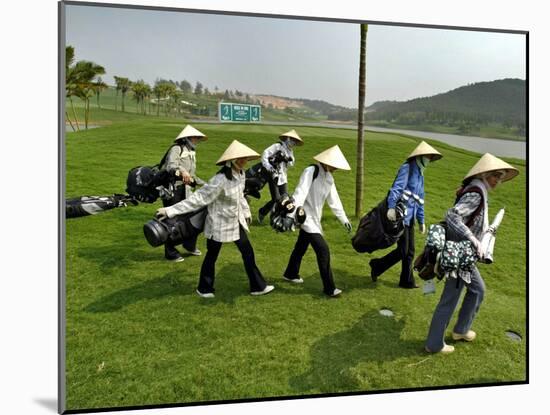 Women Wearing the Traditional Vietnamese Conical Hats Haul Golf Clubs-null-Mounted Photographic Print
