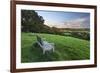 Wooden bench looking over green field countryside of High Weald on summer evening, Burwash-Stuart Black-Framed Photographic Print