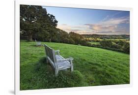 Wooden bench looking over green field countryside of High Weald on summer evening, Burwash-Stuart Black-Framed Photographic Print