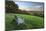 Wooden bench looking over green field countryside of High Weald on summer evening, Burwash-Stuart Black-Mounted Photographic Print