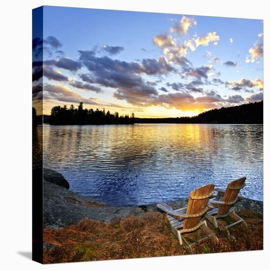 Wooden Chair on Beach of Relaxing Lake at Sunset in Algonquin Park, Canada-elenathewise-Stretched Canvas