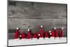 Wooden Christmas Background with Red Santa Hats for a Festive Frame or Card.-Imagesbavaria-Mounted Photographic Print