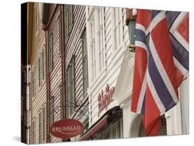 Wooden Merchants Premises and Norwegian Flag, Bryggen Old Harbour Side, Bergen, Norway, Scandinavia-James Emmerson-Stretched Canvas