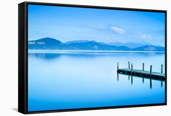 Wooden Pier or Jetty and on A Blue Lake Sunset and Sky Reflection on Water. Versilia Tuscany, Italy-stevanzz-Framed Stretched Canvas