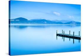 Wooden Pier or Jetty and on A Blue Lake Sunset and Sky Reflection on Water. Versilia Tuscany, Italy-stevanzz-Stretched Canvas