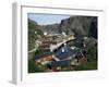 Wooden Red Houses on Stilts Over Water at the Fishing Village of Nusfjord, Lofoten Islands, Norway-Tony Waltham-Framed Photographic Print