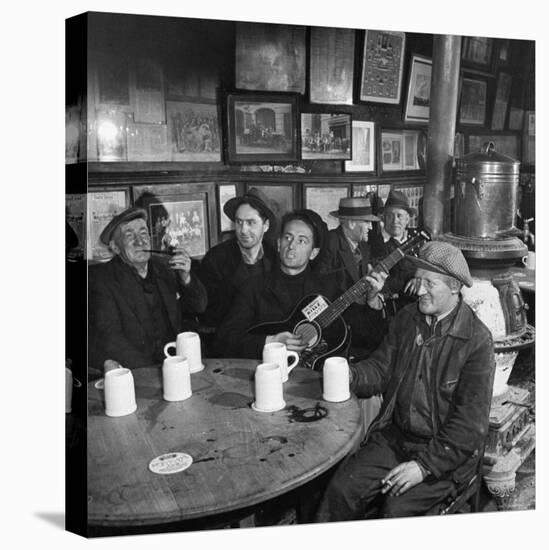 Woody Guthrie Playing and Singing for Patrons of Mcsorley's Bar-Eric Schaal-Stretched Canvas